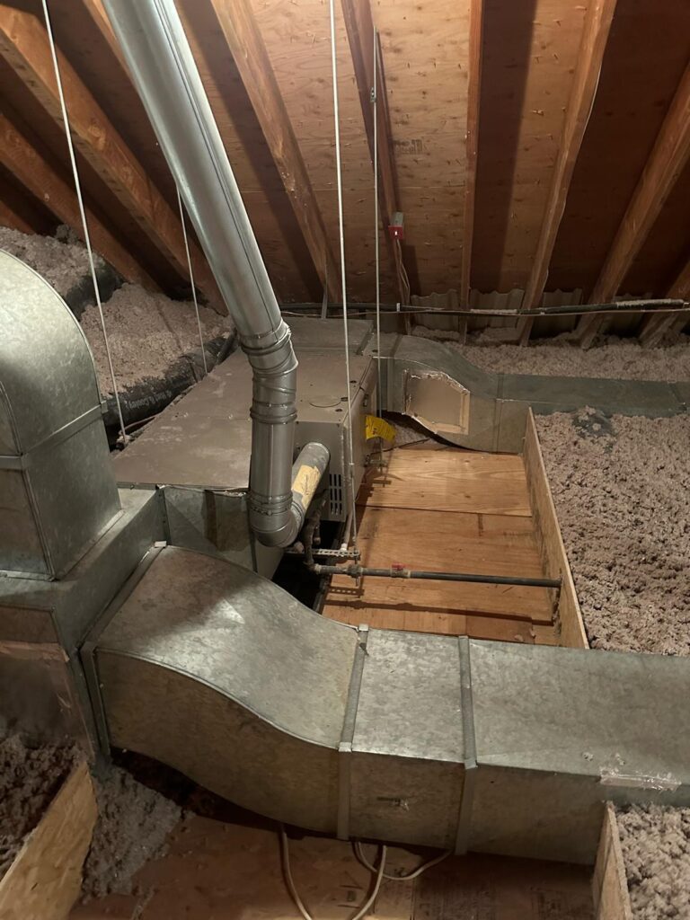attic access opening beside metal duct