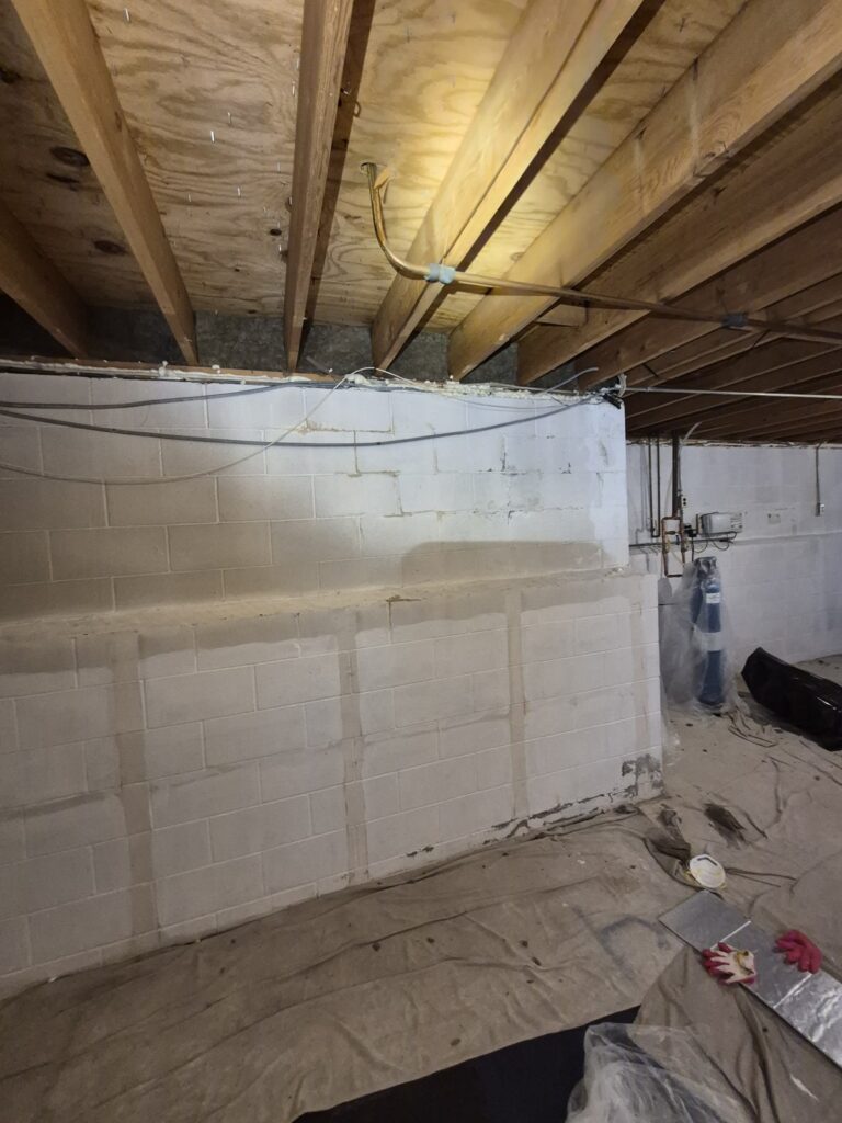 basement wall and exposed ceiling joists