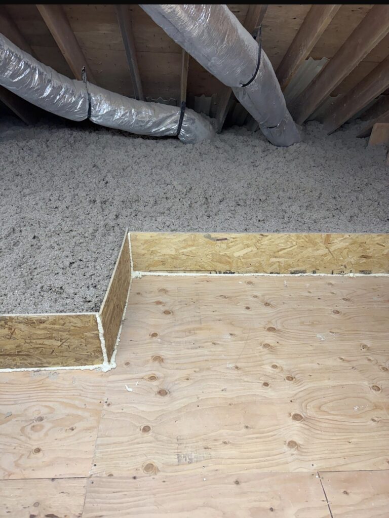 cellulose attic insulation beside plywood floor