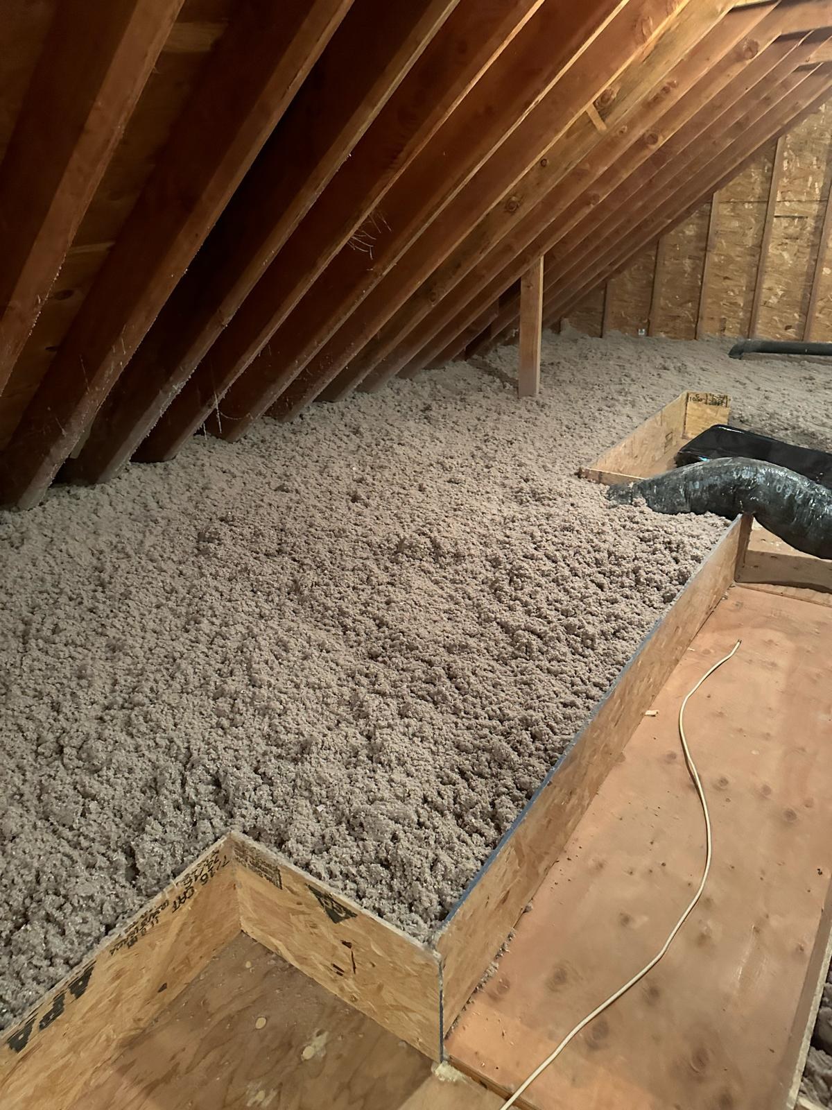 cellulose insulation along raised attic walkway