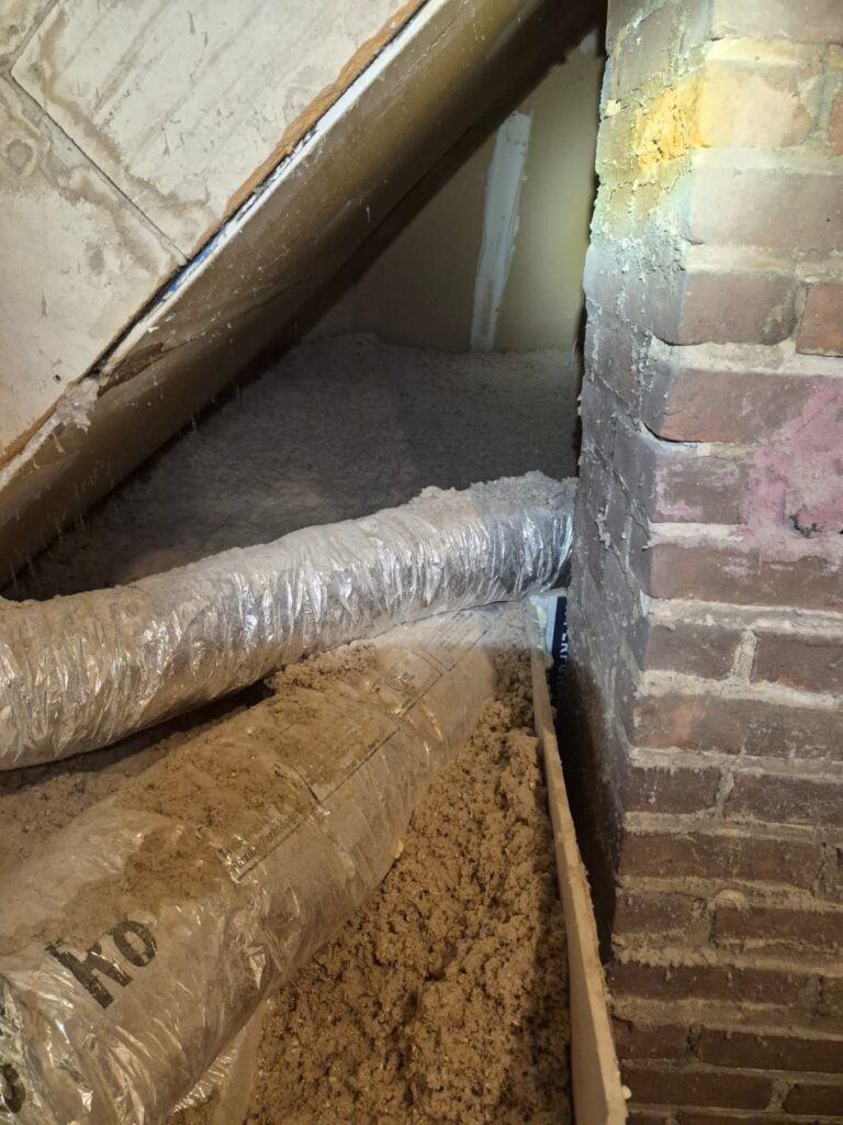 cellulose insulation near brick chimney and duct