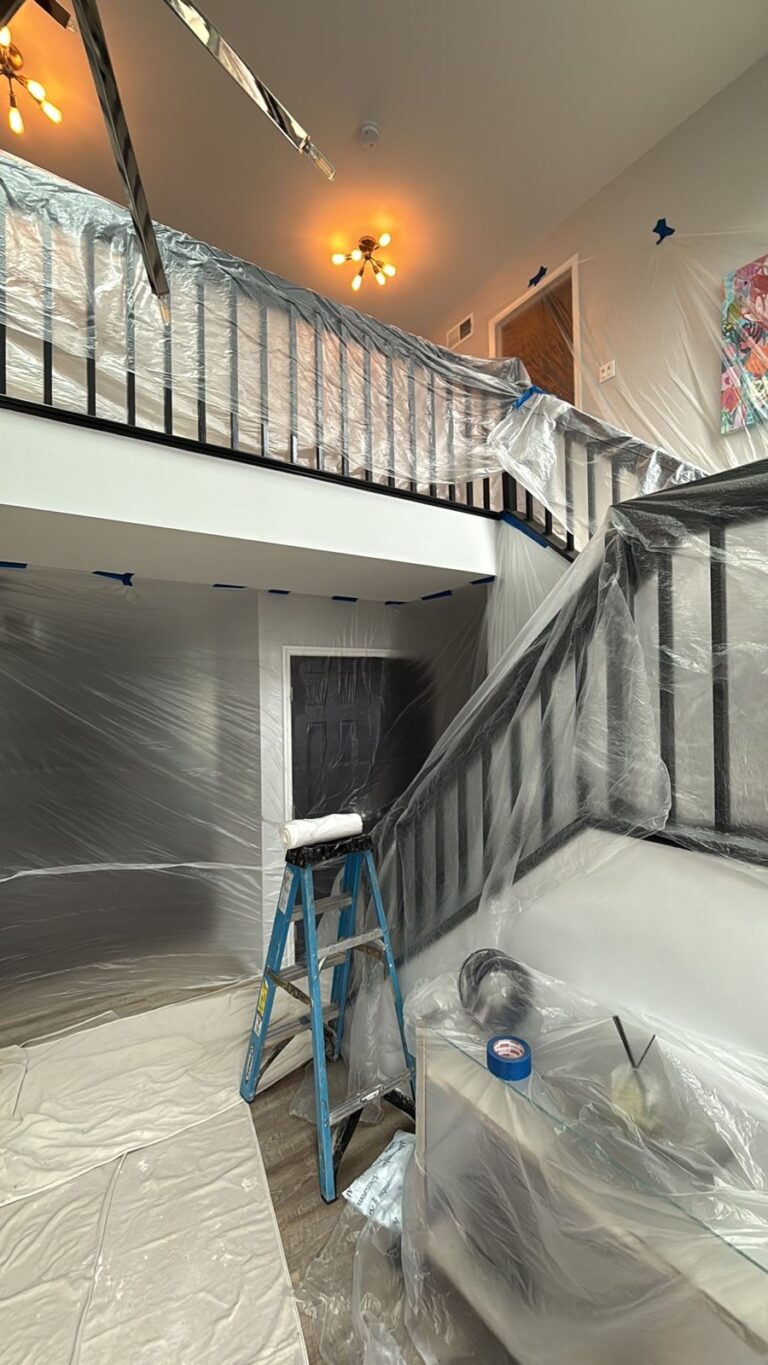 foyer and staircase with protective sheeting