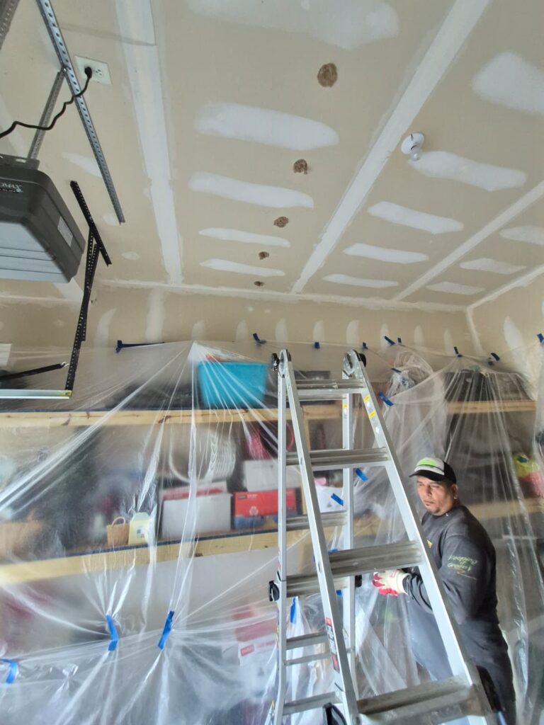 garage ceiling drywall patching in progress