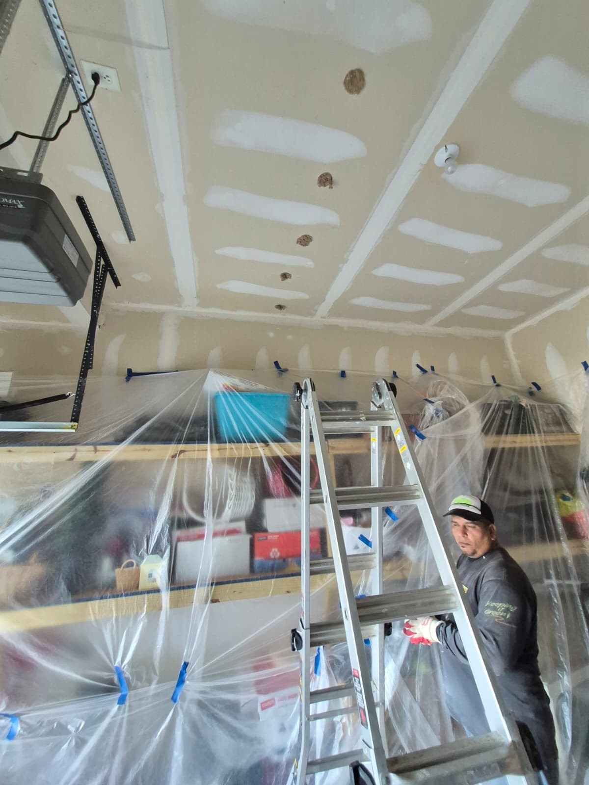 garage ceiling drywall patching in progress