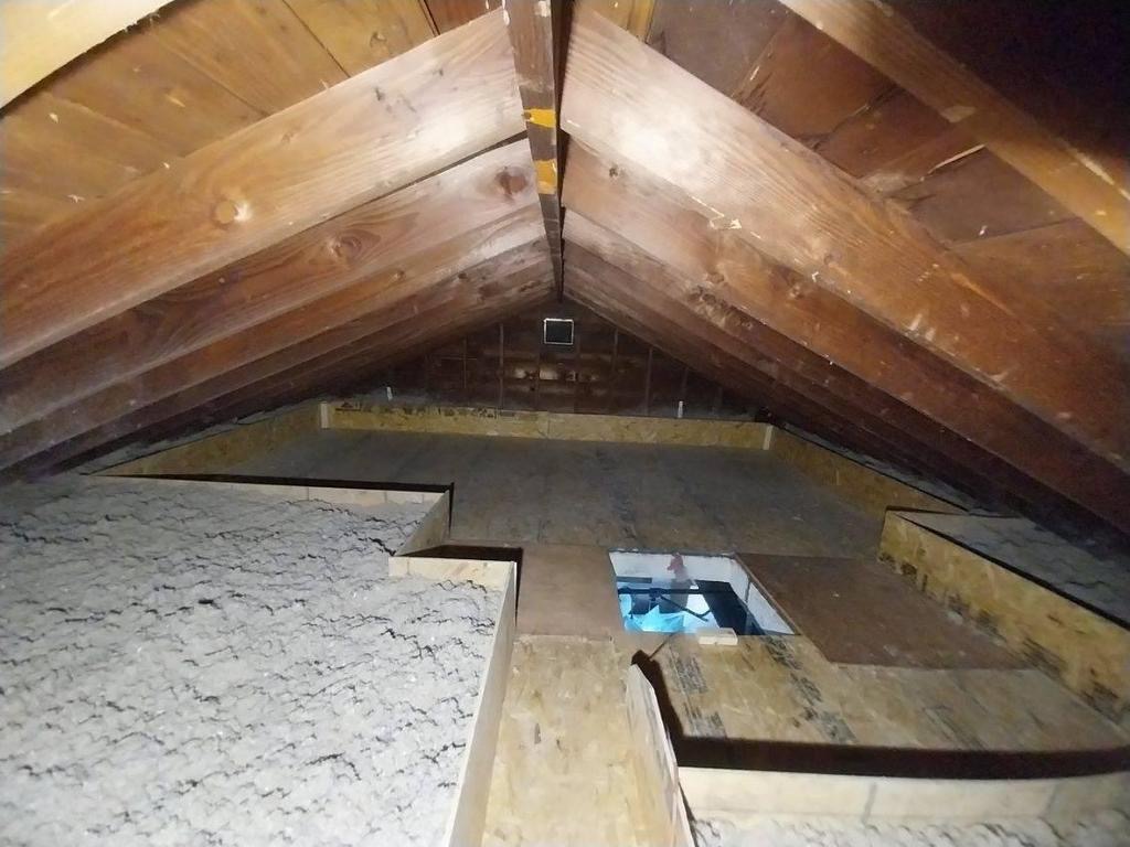 After: clean, properly insulated attic with fresh insulation and a sealed access hatch